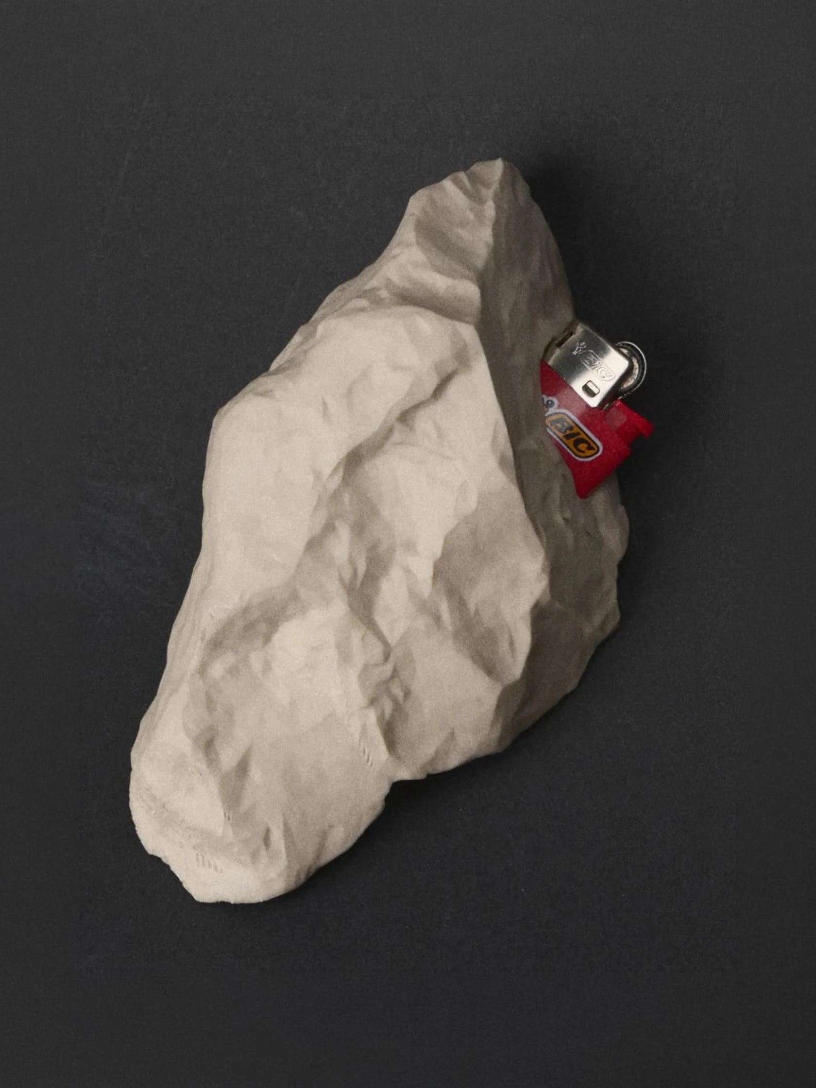A lighter concealed within a stone-shaped casing.